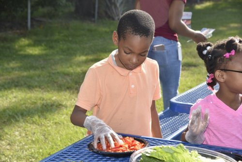 Orlando Health staff members volunteer at Orange Center Elementary School’s Healthy Living Garden  