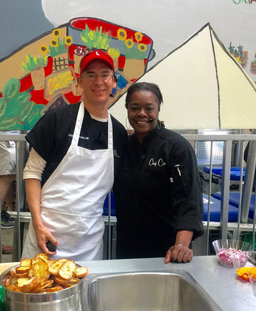 Dr. Chris Funes, an Our Lady of the Lake pediatrician, cooking at the Red Stick Farmer’s Market with host Chef Celeste Gill. [BREADA]