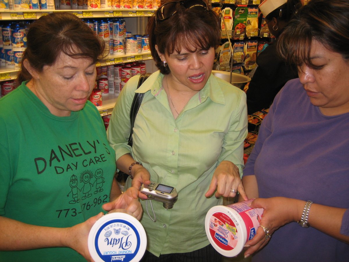 Participants of a Cooking Matters program learn about the benefits of label reading during a grocery store tour. [Share Our Strength]