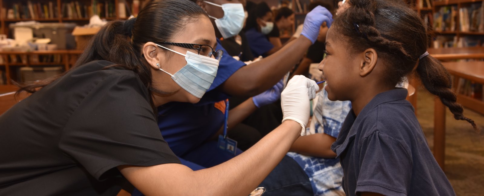 Health professionals check Orange Center Elementary School students' health metrics