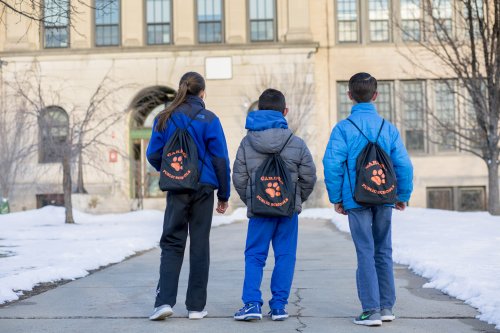 Students wearing backpacks stocked with meal supplies (Heywood Hospital)