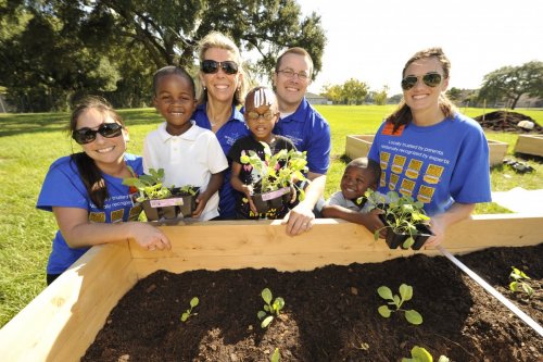 Orlando Health staff members volunteer at Orange Center Elementary School’s Healthy Living Garden  